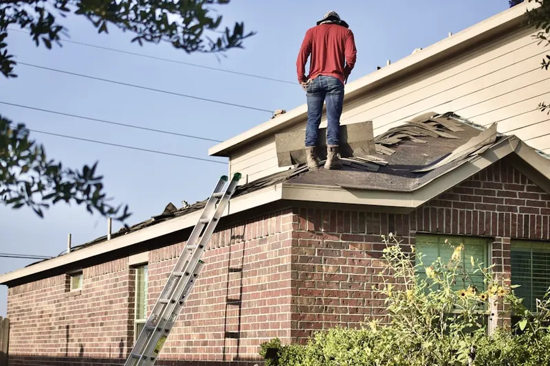 Professional roofer working on a residential roof in Dulles Town Center